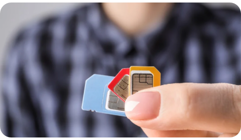 photo of a hand holding three SIM cards.